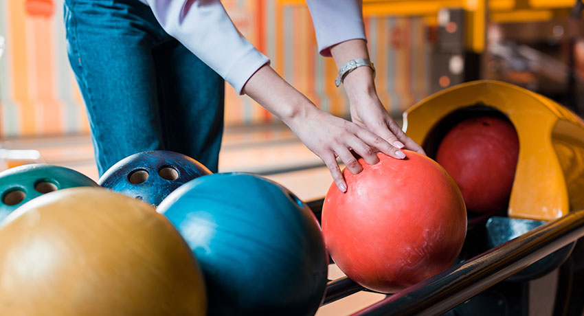  Hands taking a bowling ball