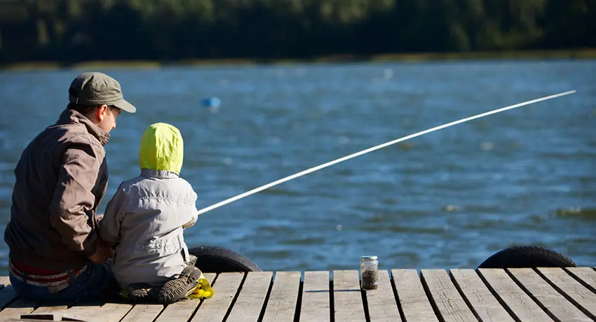 Adult and child fishing from a pier in Halmstad
